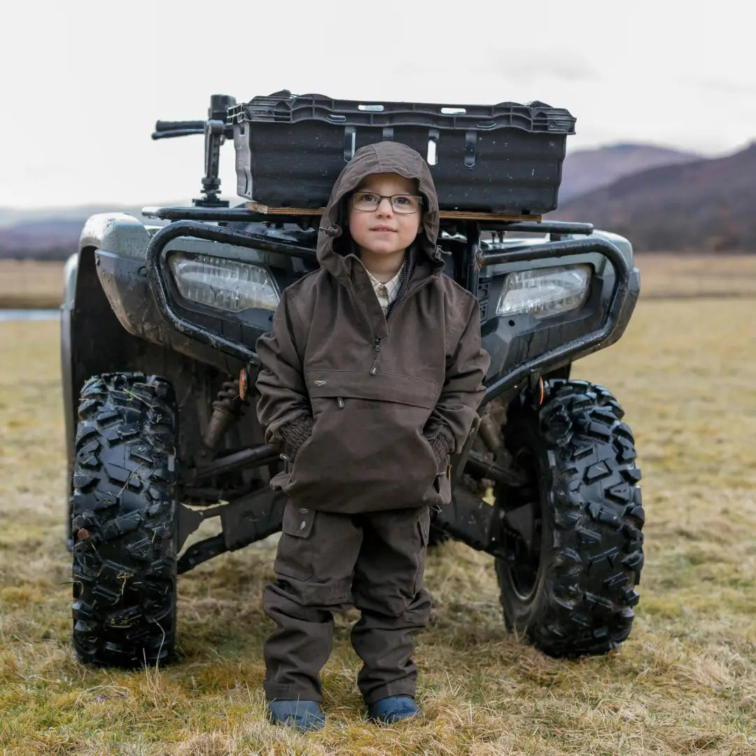 Young rider in front of an ATV wearing a Fife Struther Junior Smock