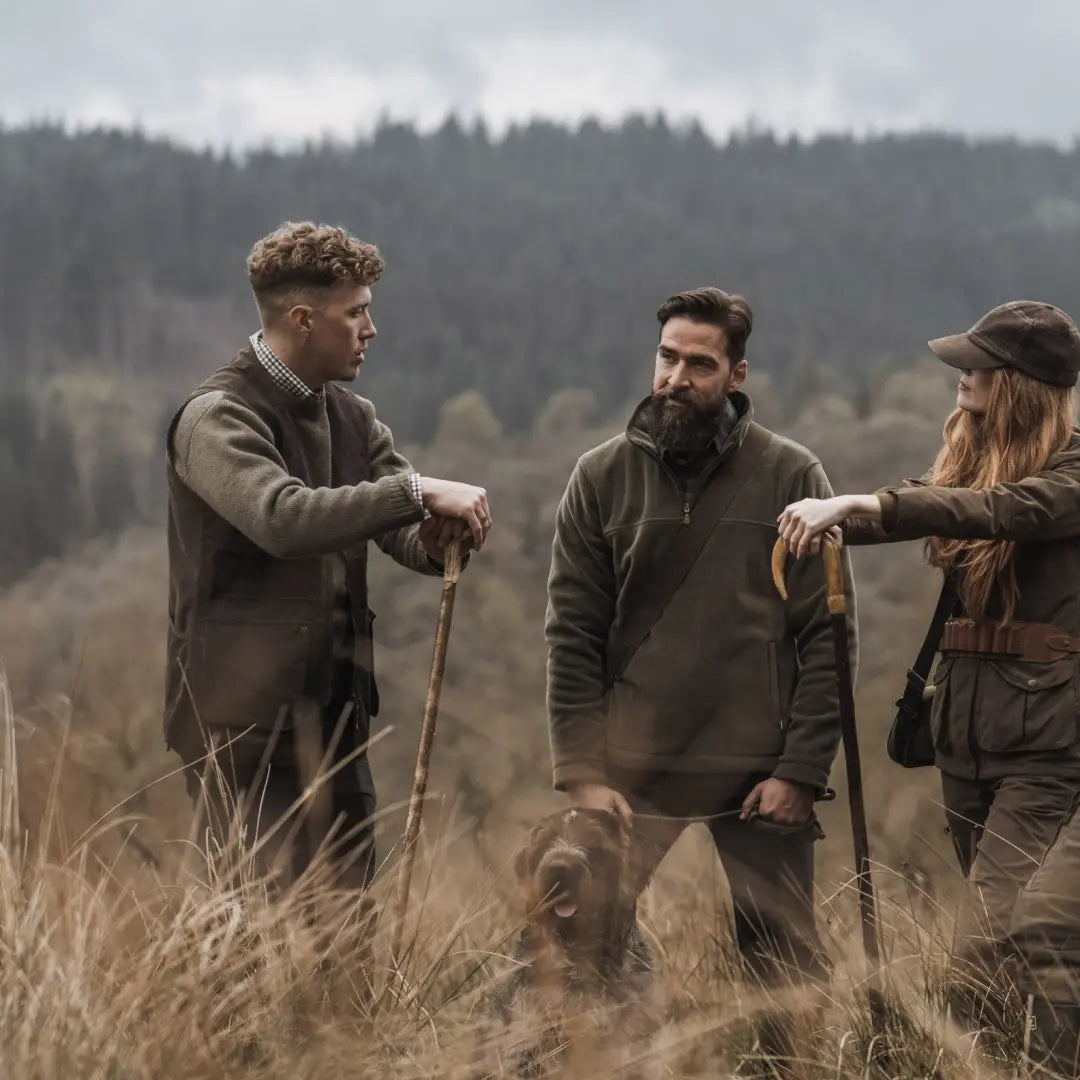 Three people in outdoor gear with a dog, showcasing the Fife Struther Shooting Vest