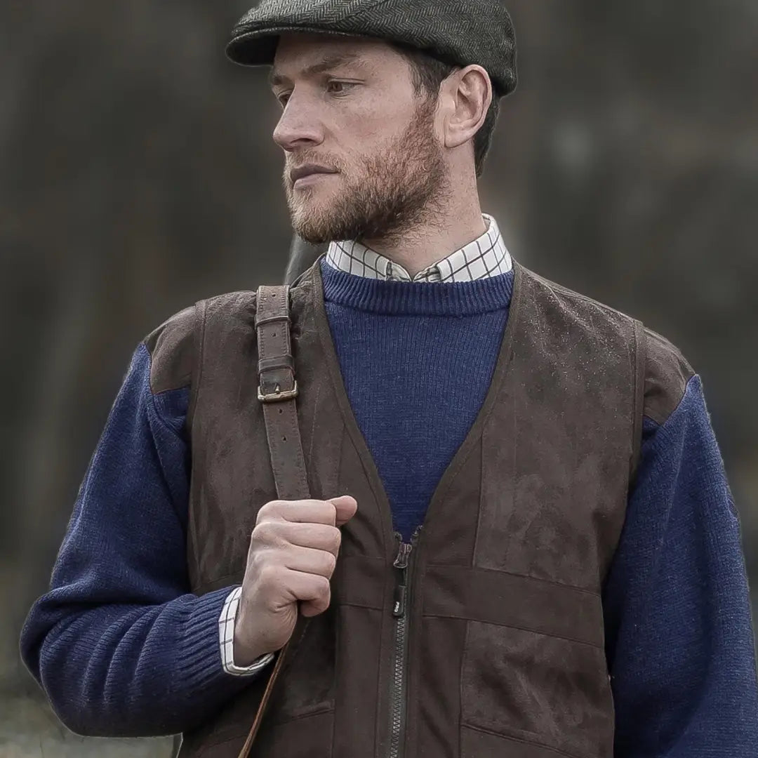 Man in flat cap and blue sweater showcasing Fife Struther Shooting Vest