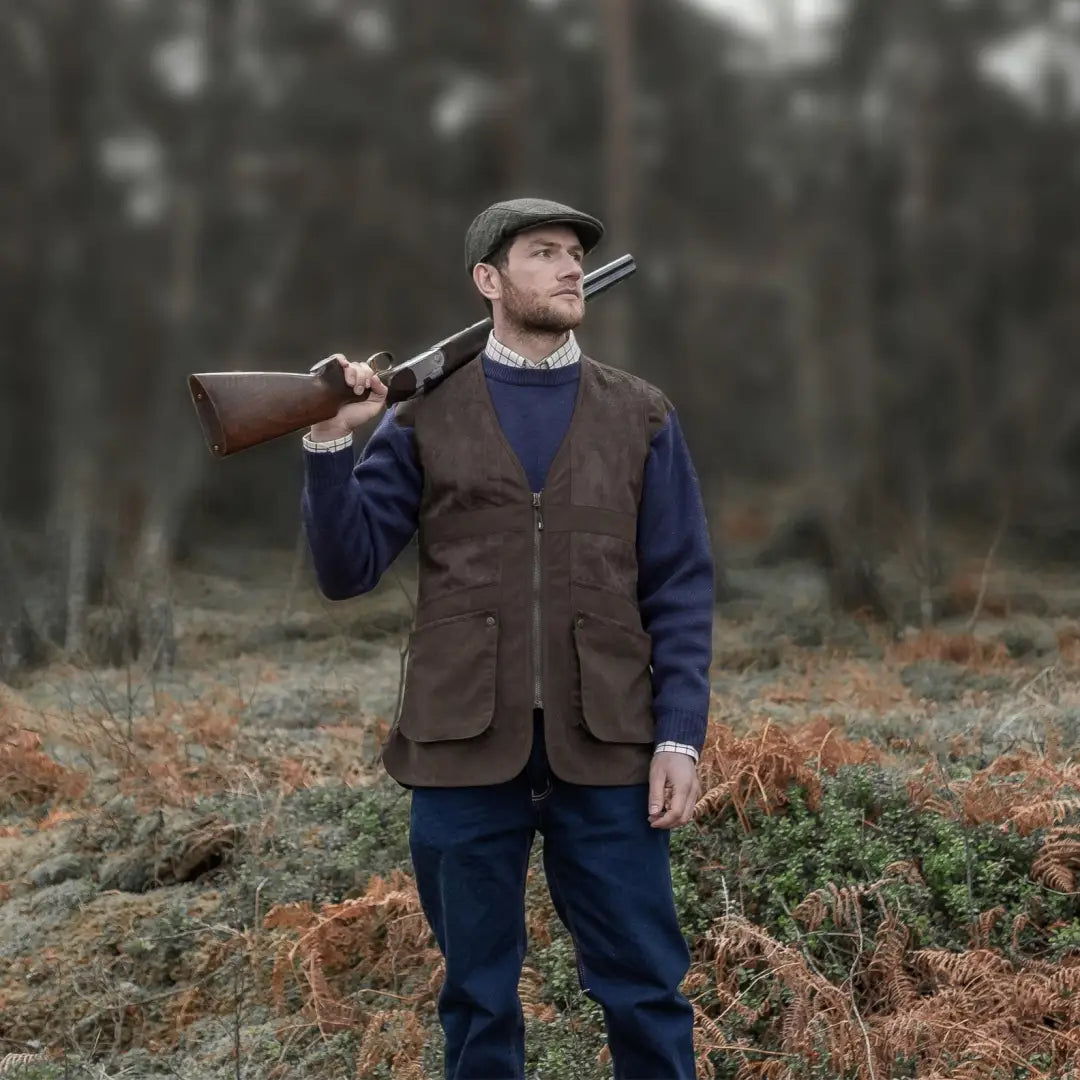 Man in hunting gear with a shotgun wearing a Fife Struther Shooting Vest