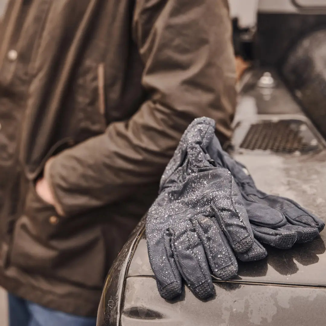 Frost-covered gray Hoggs of Fife Struther Waterproof Gloves on a surface