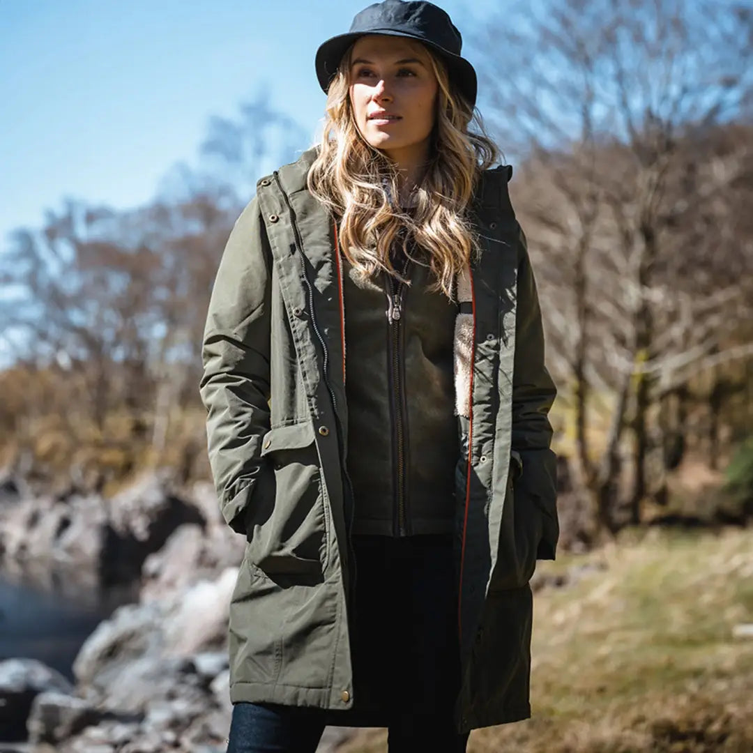 Woman in an olive green long coat from Hoggs of Fife, perfect for country clothing shines