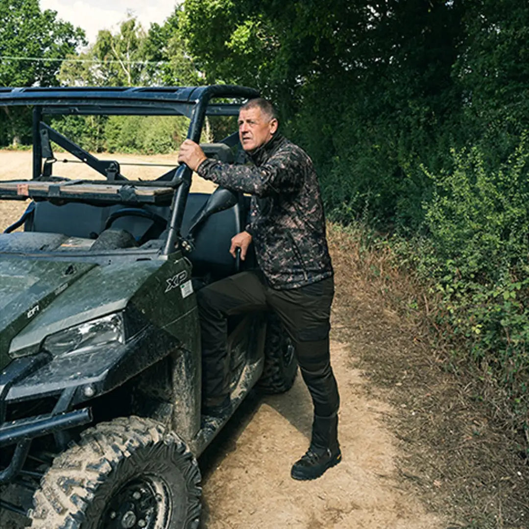 Off-road utility vehicle in camo next to Jack Pyke Ashcombe Technical Fleece Jacket