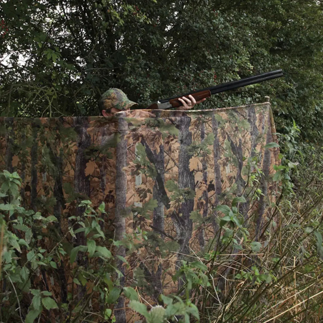 Camouflaged Jack Pyke Clearview Hide Net with rifle barrel for hunting adventures