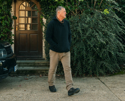 Man in black hoodie and khaki pants wearing Jack Pyke Country Fleece Hoodie