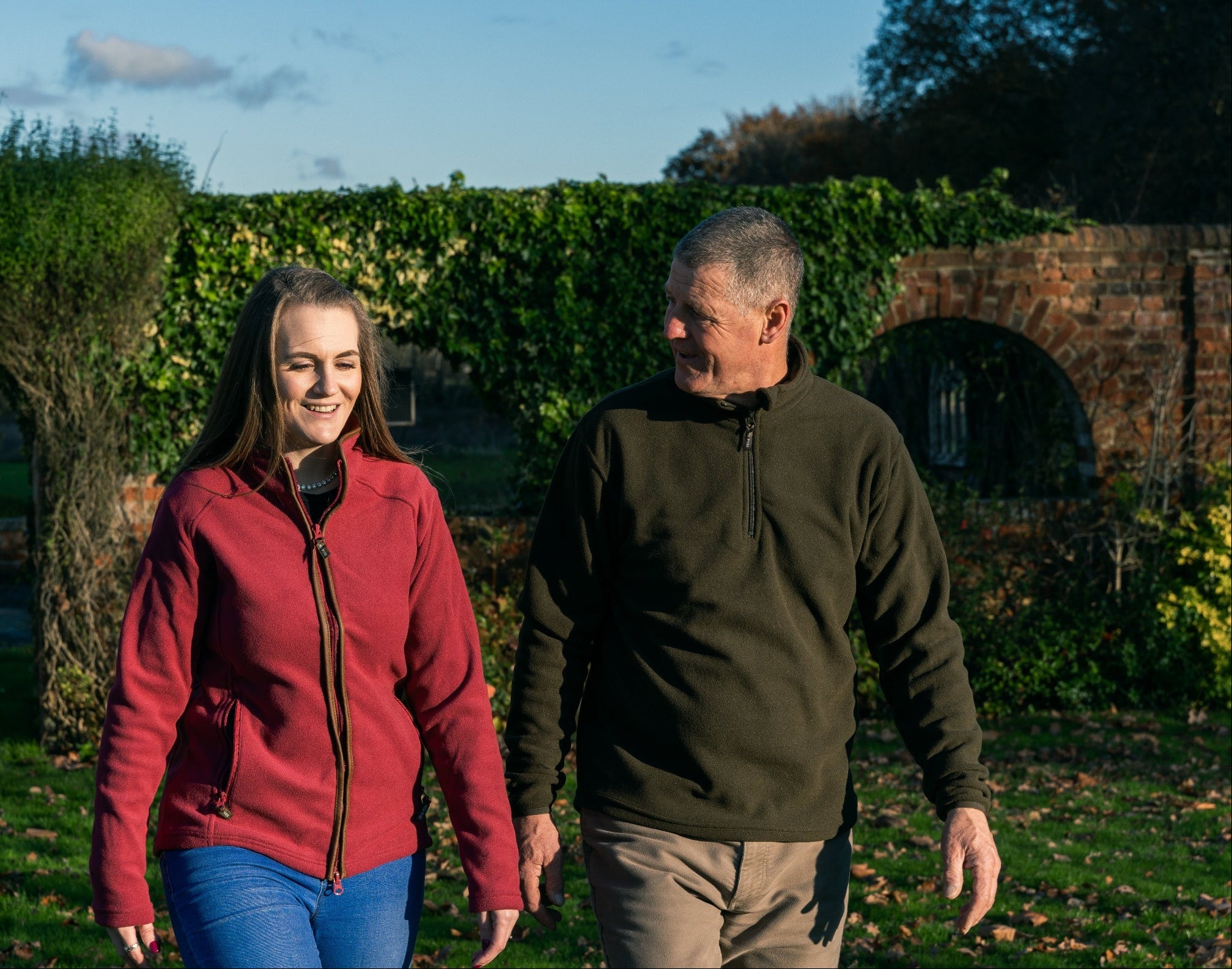 Two people walking in stylish Jack Pyke County Fleece Top outdoors