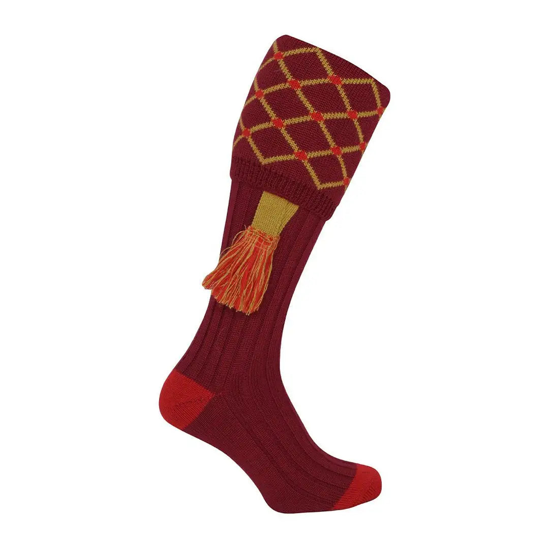 Burgundy knee-high Jack Pyke Diamond Shooting Socks with diamond pattern and orange tassel