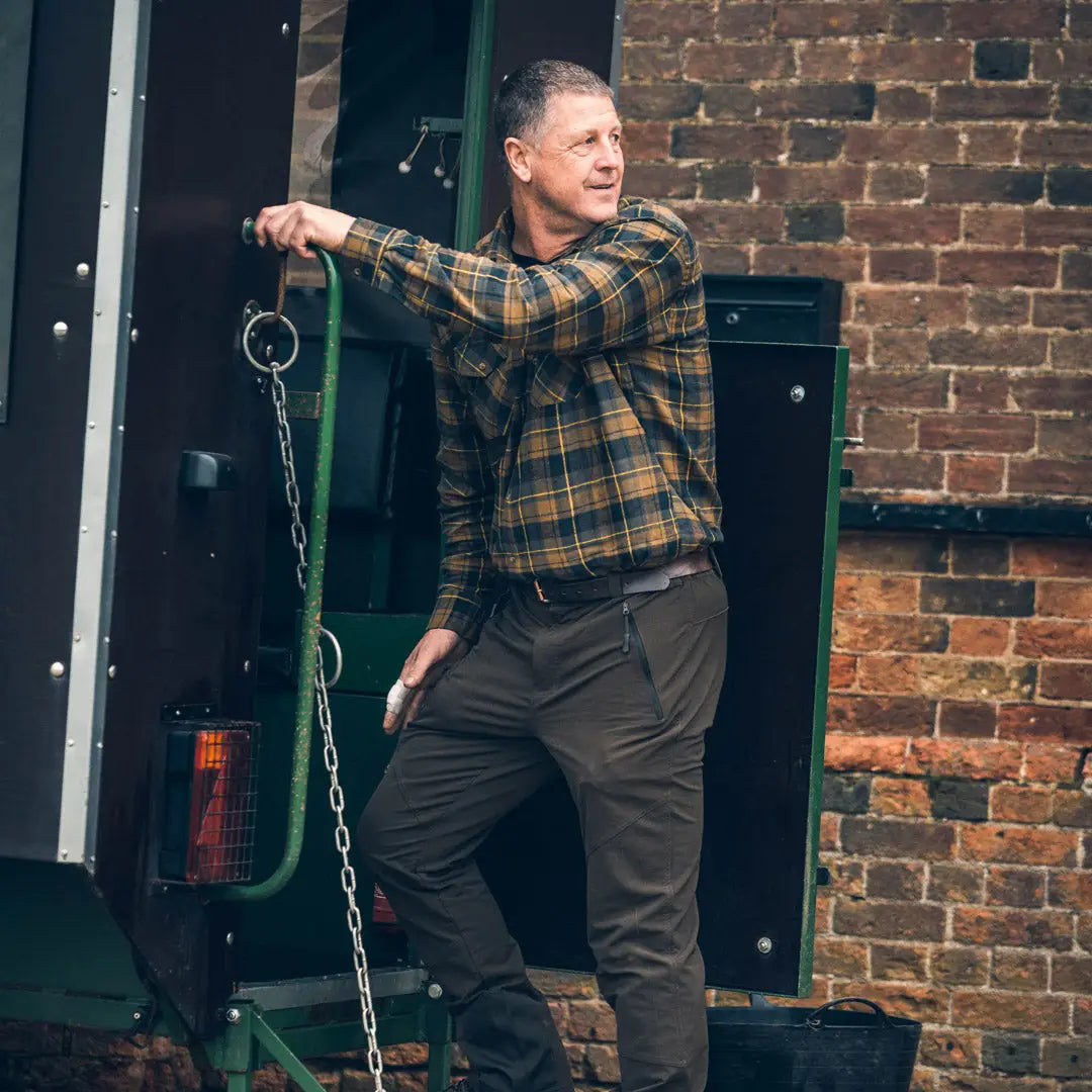 Middle-aged man in plaid shirt and dark pants showcasing Jack Pyke Flannel Shirt