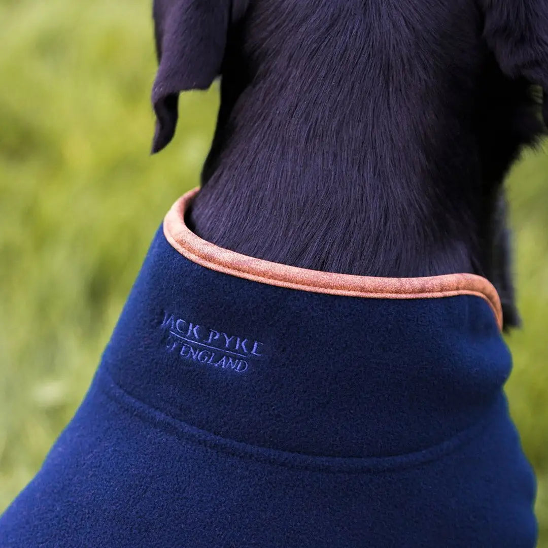 Navy blue Jack Pyke Fleece Dog Coat with orange trim and branding for stylish pups