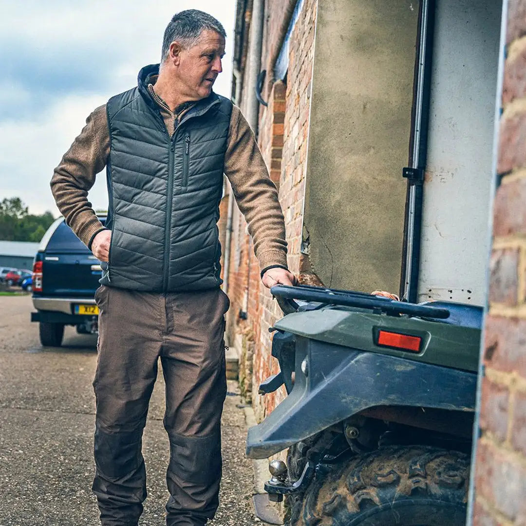 Middle-aged man in a Jack Pyke Hybrid Quilted Gilet next to a vehicle