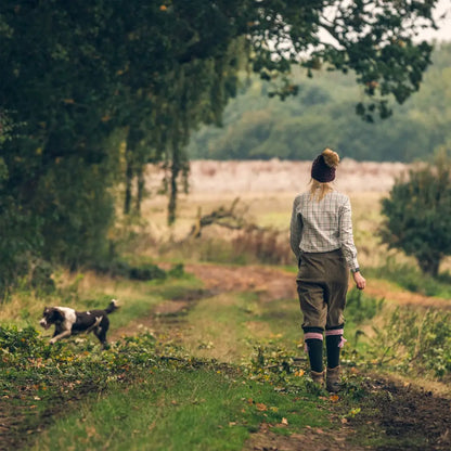 Person walking a dog on a rural path in a Jack Pyke Ladies Countryman Shirt