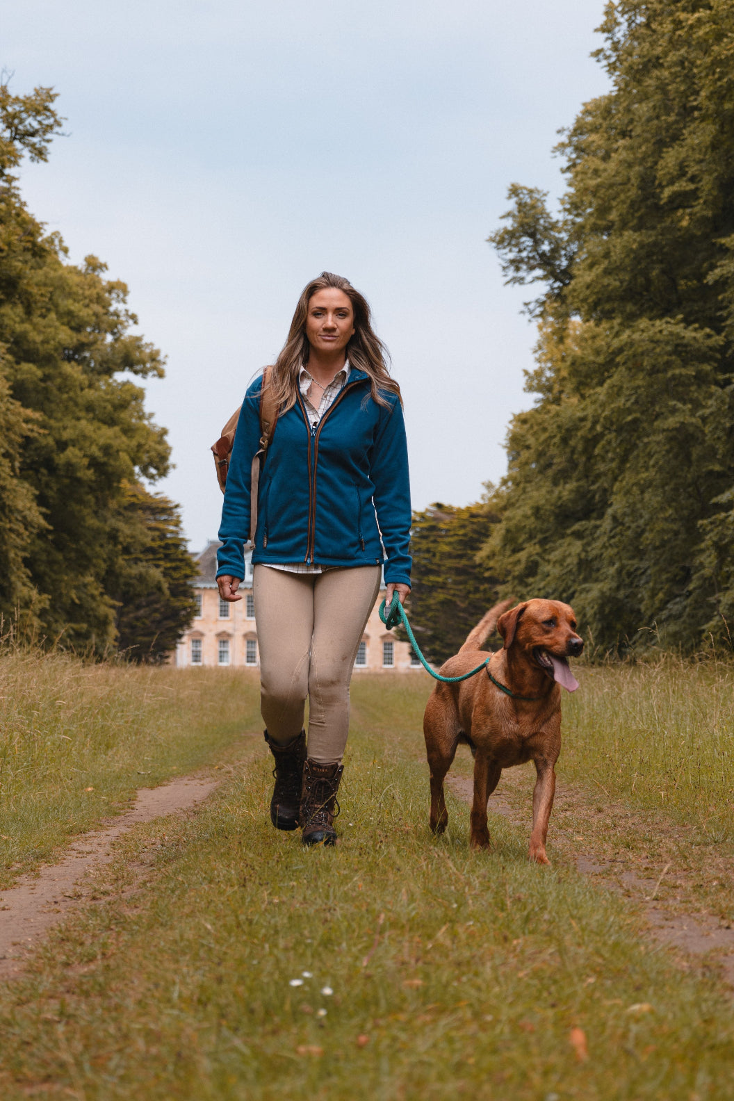 Woman walking dog in Jack Pyke Ladies Fleece Jacket enjoying the outdoors