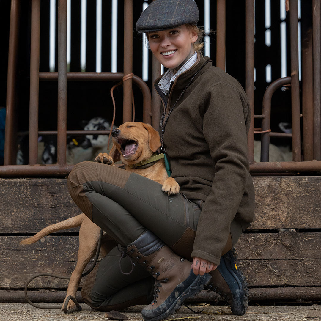 Woman in Jack Pyke Ladies Technical Trousers enjoying time with her puppy outdoors