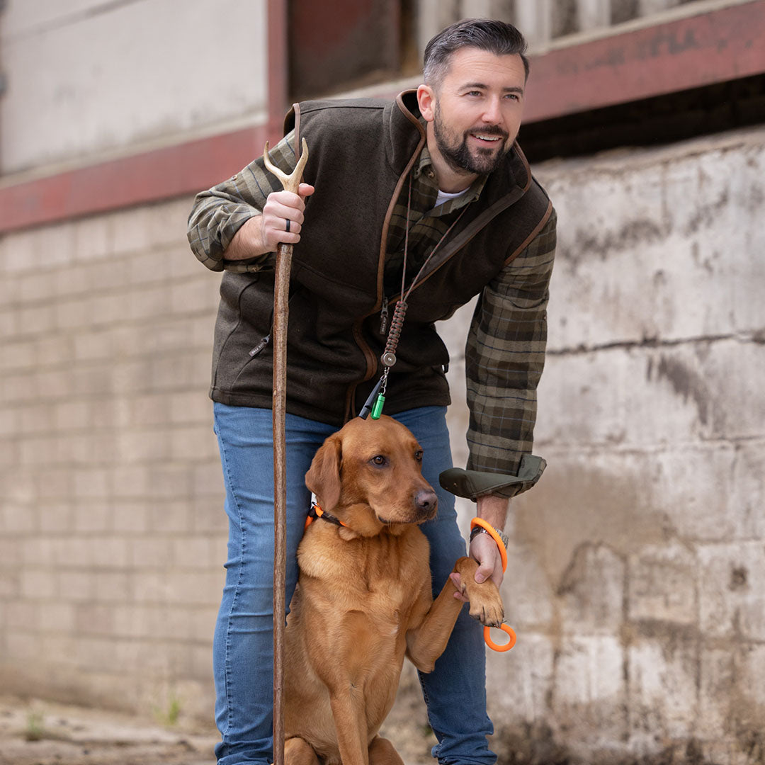 Man with dog wearing Jack Pyke Melange Fleece Gilet in Dark Olive color