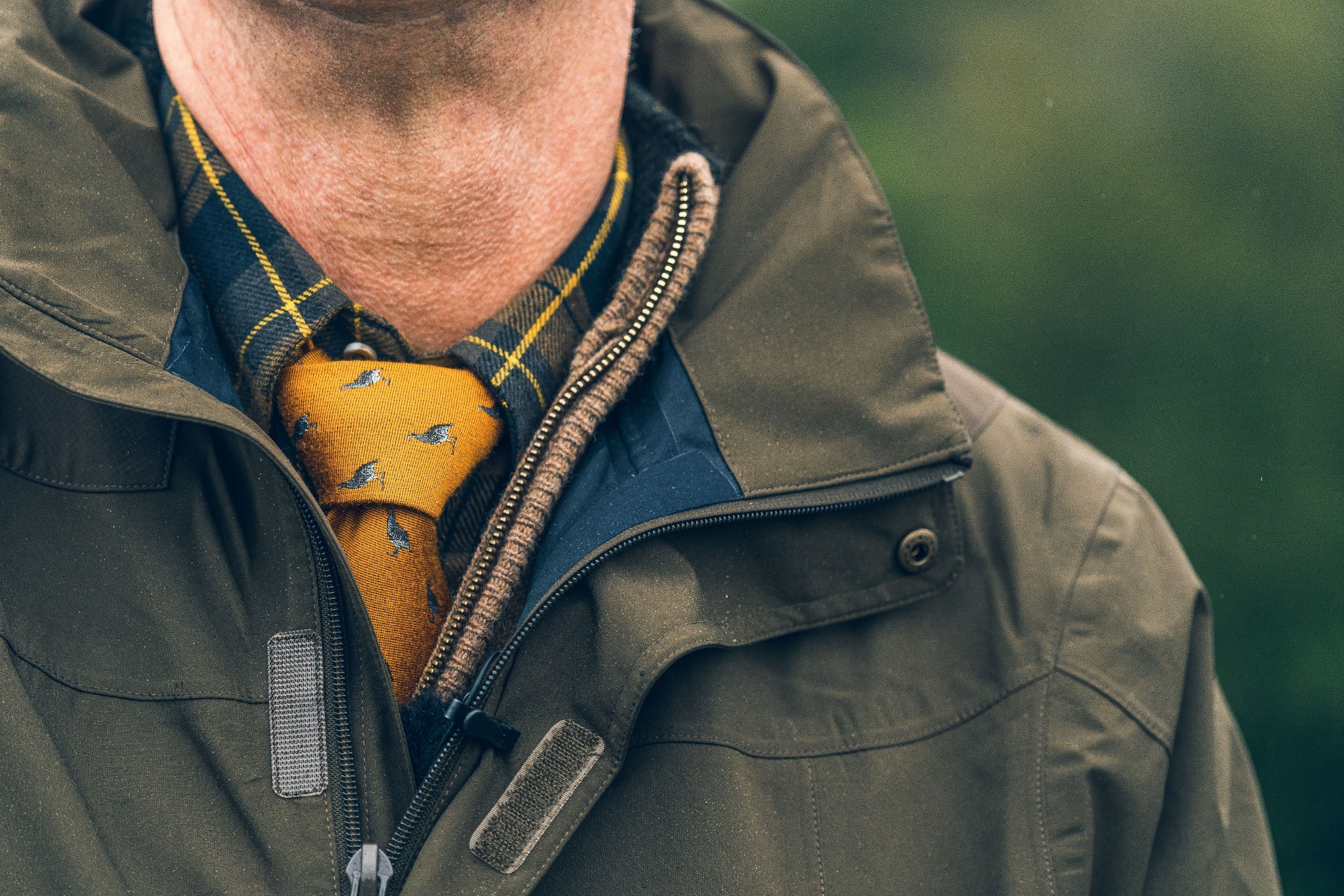 Olive green jacket with yellow tie featuring the Jack Pyke Partridge Silk Tie style