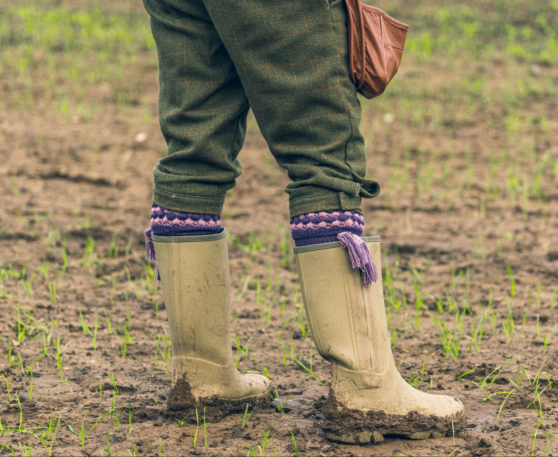 Muddy rubber boots paired perfectly with Jack Pyke Pebble Shooting Socks for outdoor adventures