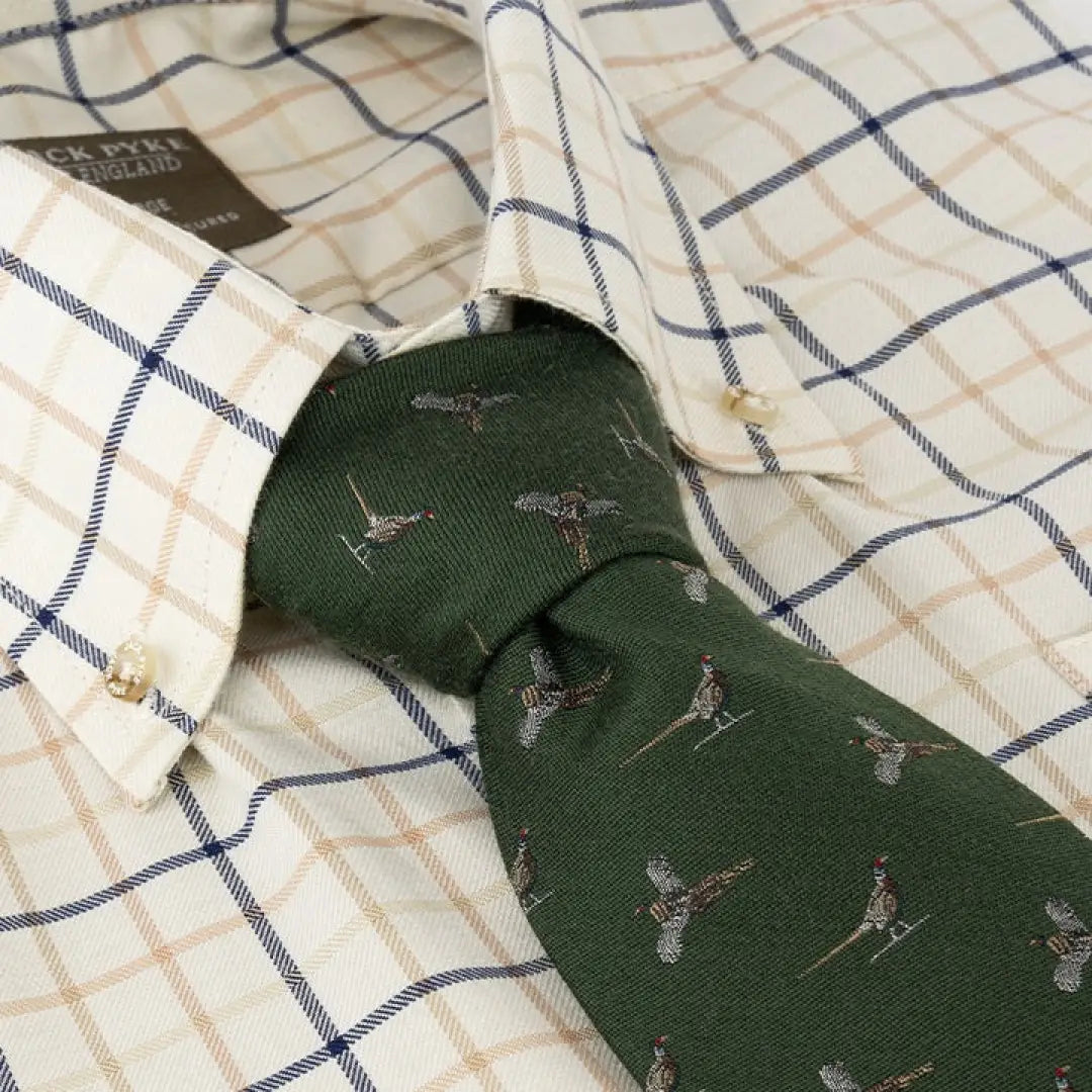 Green Jack Pyke silk tie with pheasant pattern on a checkered shirt collar