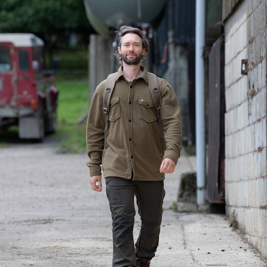 Man in an olive green Jack Pyke Polar Fleece Shirt showcasing style and comfort