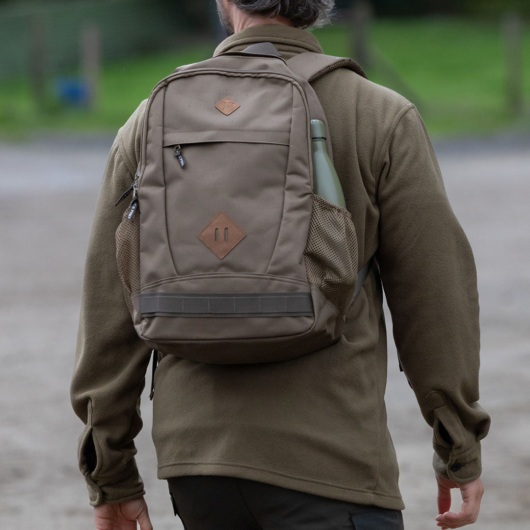 Khaki backpack with water bottle, perfect for adventures in a Jack Pyke Polar Fleece