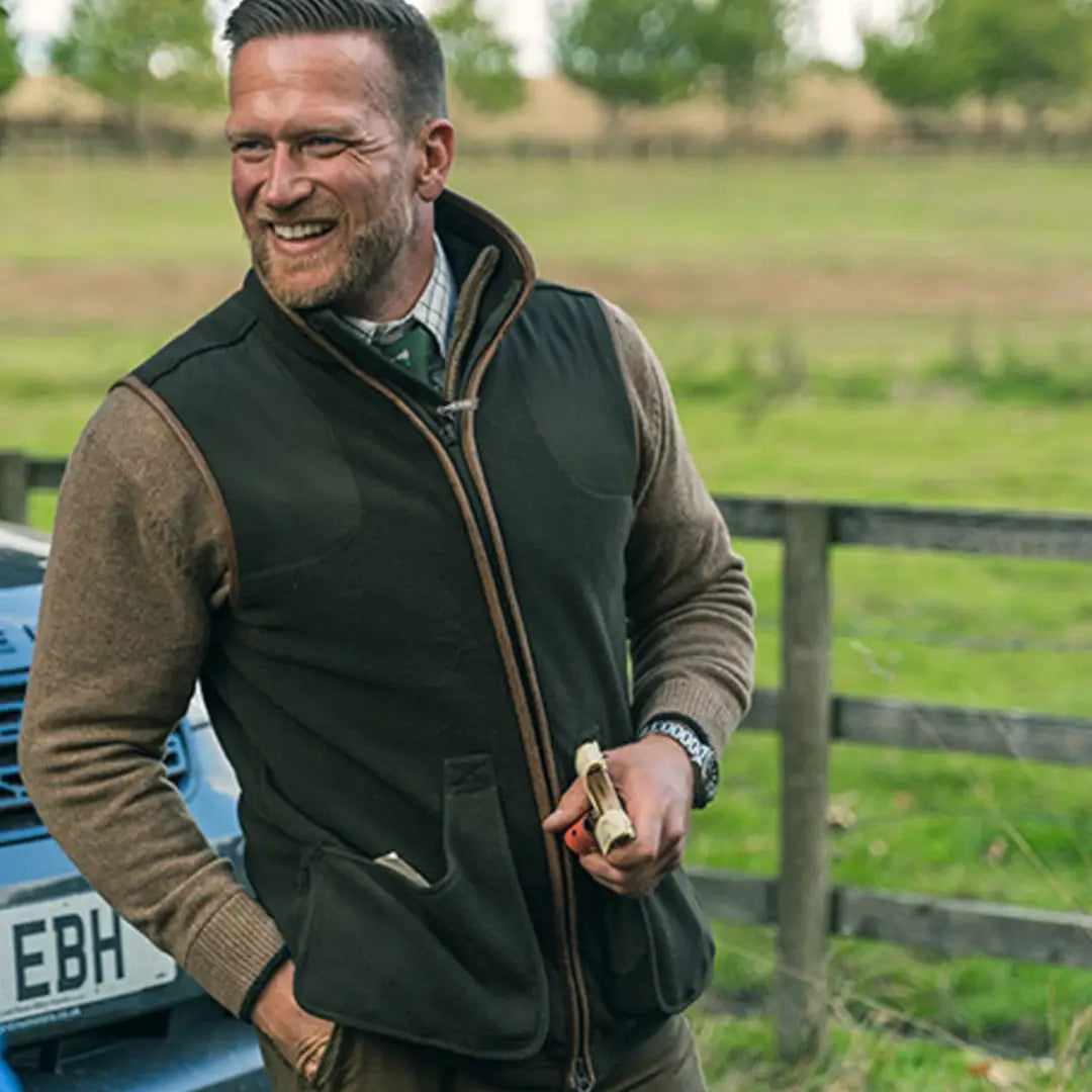 Smiling man in Jack Pyke’s Shooters Gilet, ready for outdoor adventures