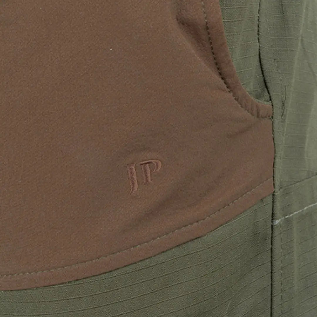 Pocket seam detail on brown and green fabric with JT initials on Jack Pyke Technical Hybrid Trousers