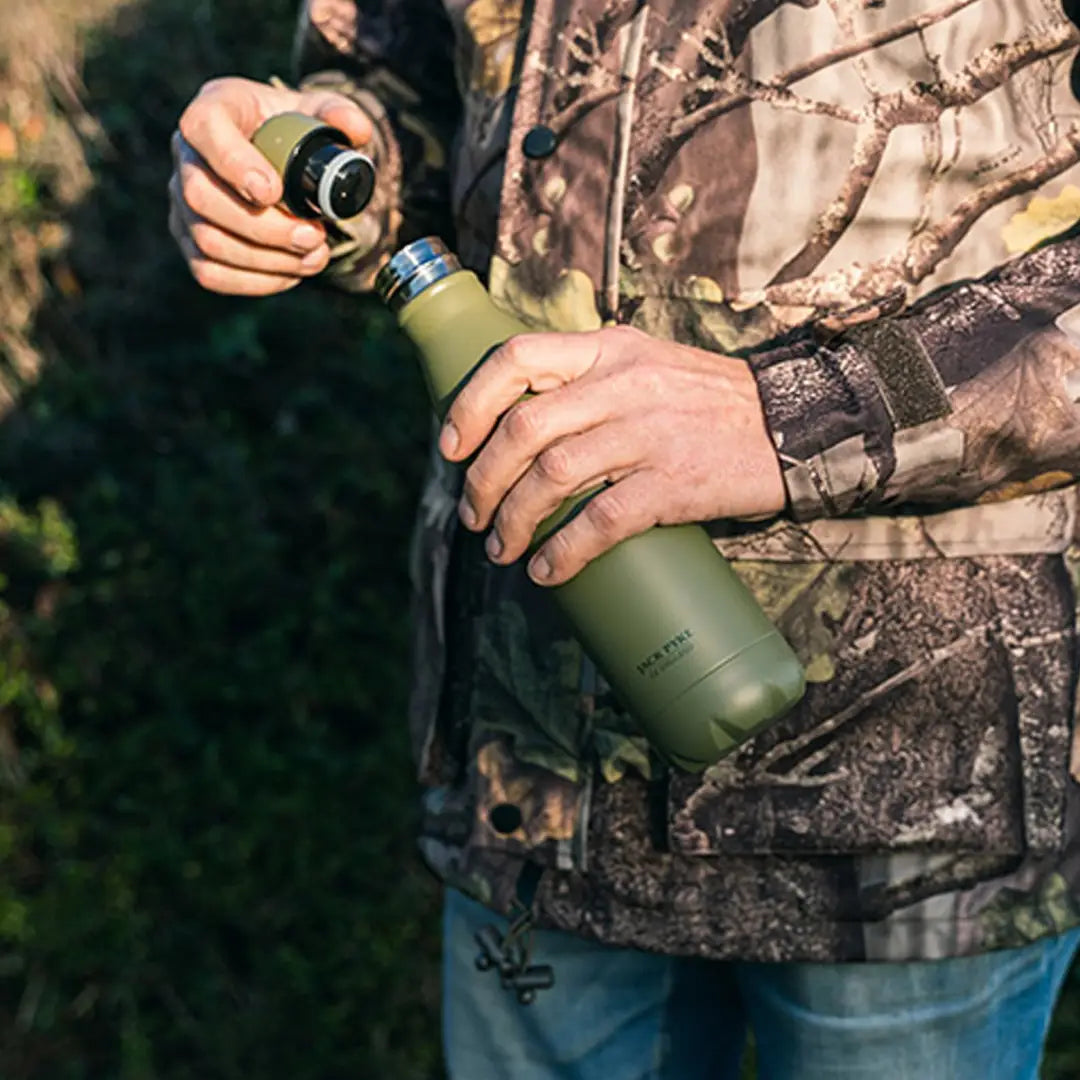 Hands in camo opening a Matte Green Jack Pyke Thermal Bottle for hydration on the go