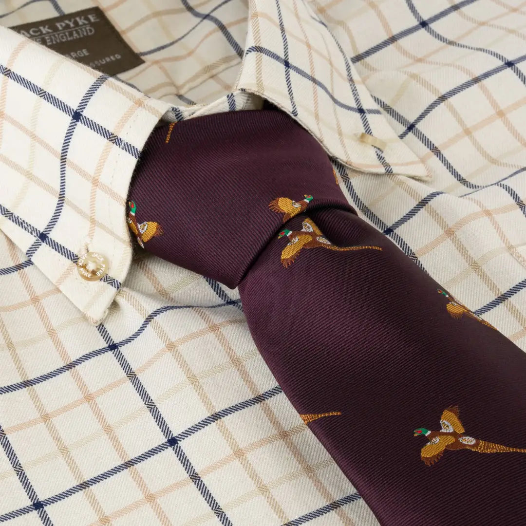 Purple Jack Pyke Tie with bird motifs paired with a checkered shirt collar