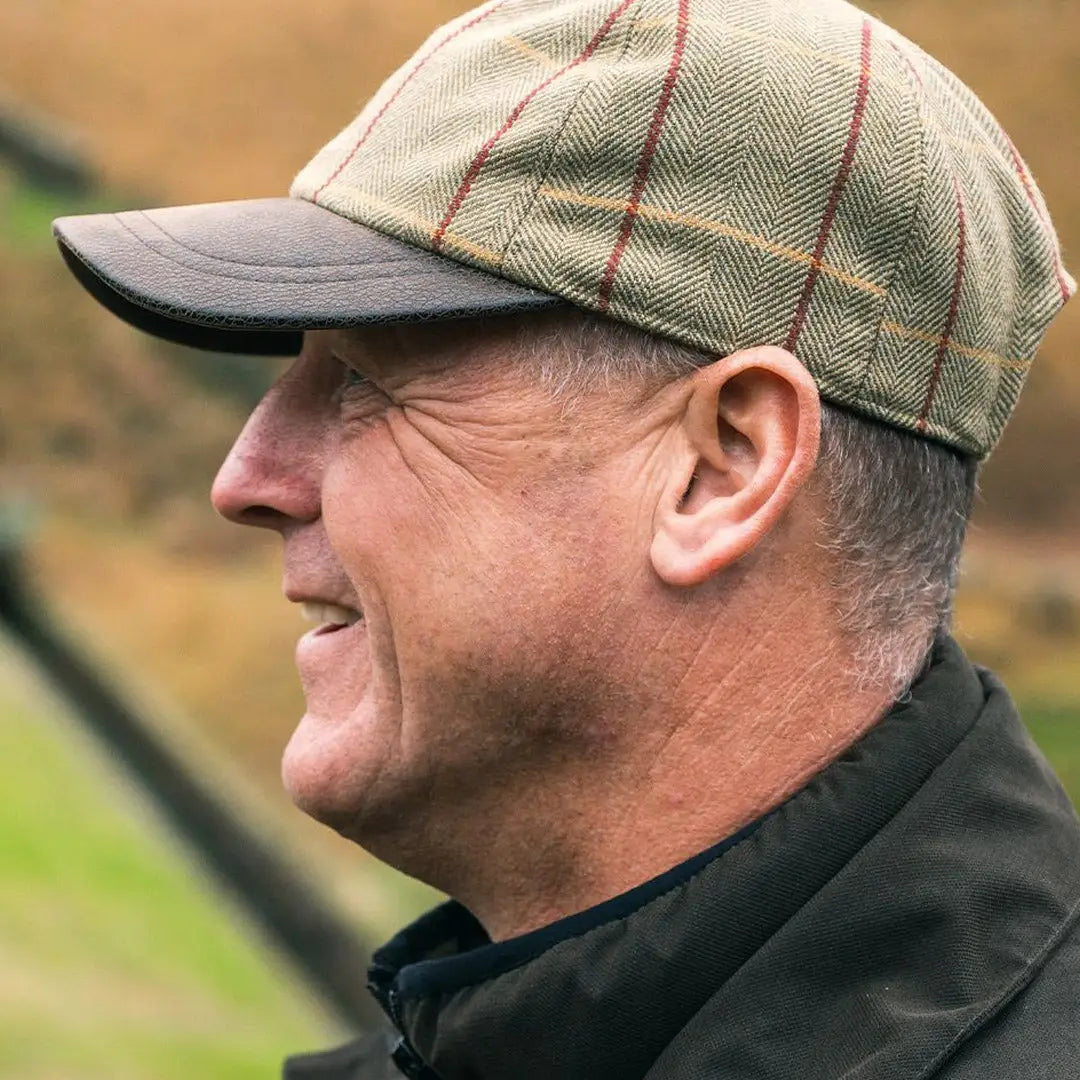 Middle-aged man in a Jack Pyke Tweed Baseball Cap with faux leather peak and dark brim