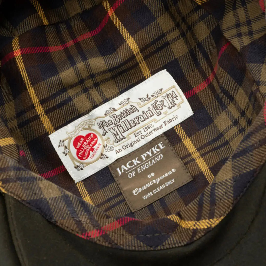 Clothing label on a Barbour waxed jacket with plaid lining for Jack Pyke Wax Flat Cap