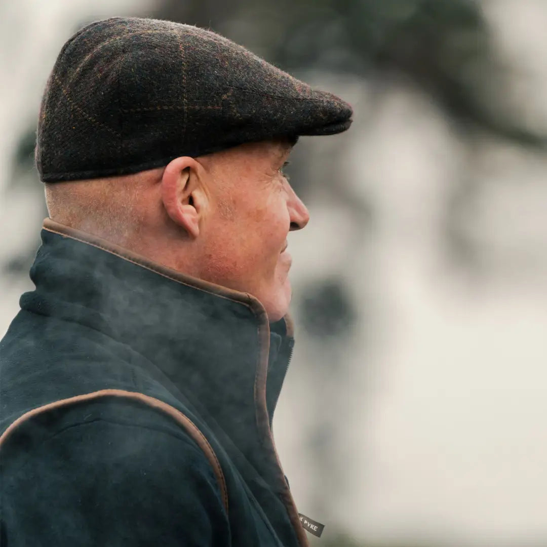 Profile view of a person in a Jack Pyke Wool Blend Flat Cap and coat