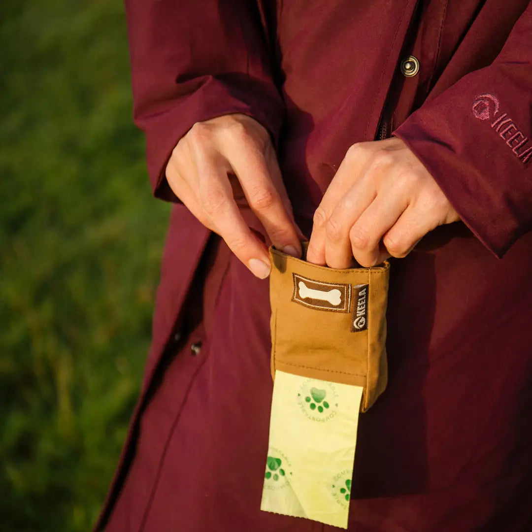 Open yellow Keela Dog Treat Pouch showing a metal clasp, perfect for your treat bag