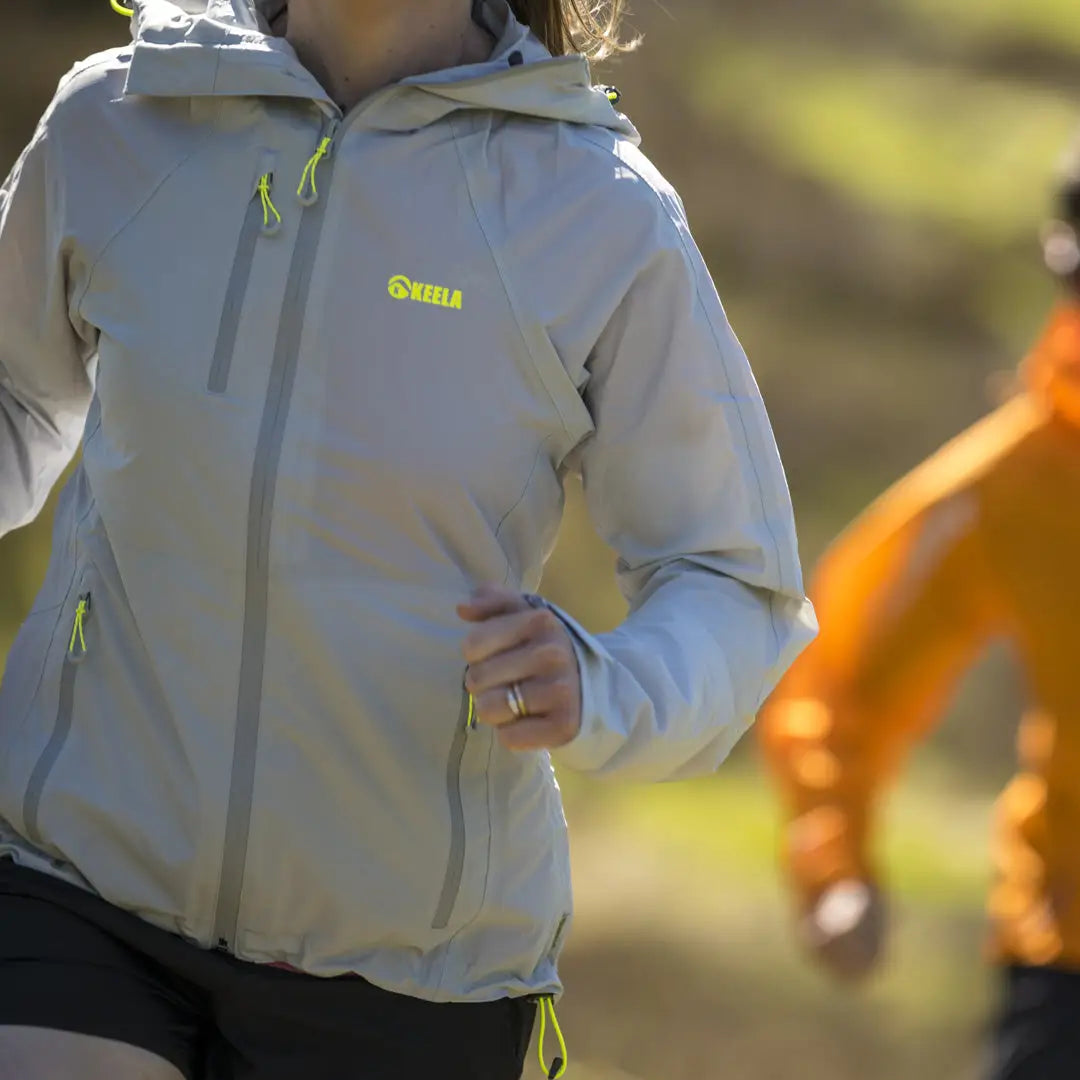 Light gray Keela Womens Storm Jacket with neon green accents and Oura branding