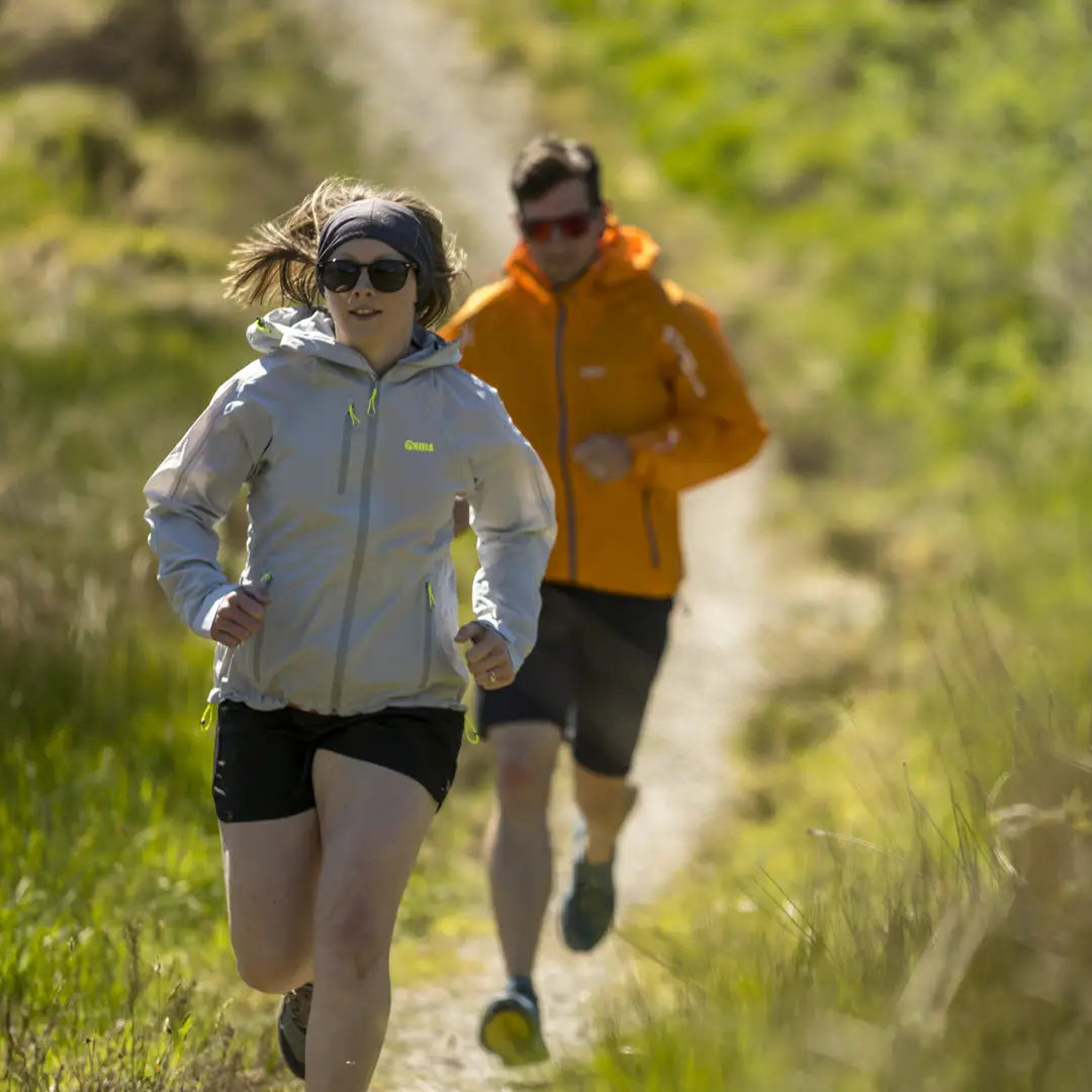 Two joggers in stylish outdoor gear, featuring the Keela Womens Storm Jacket