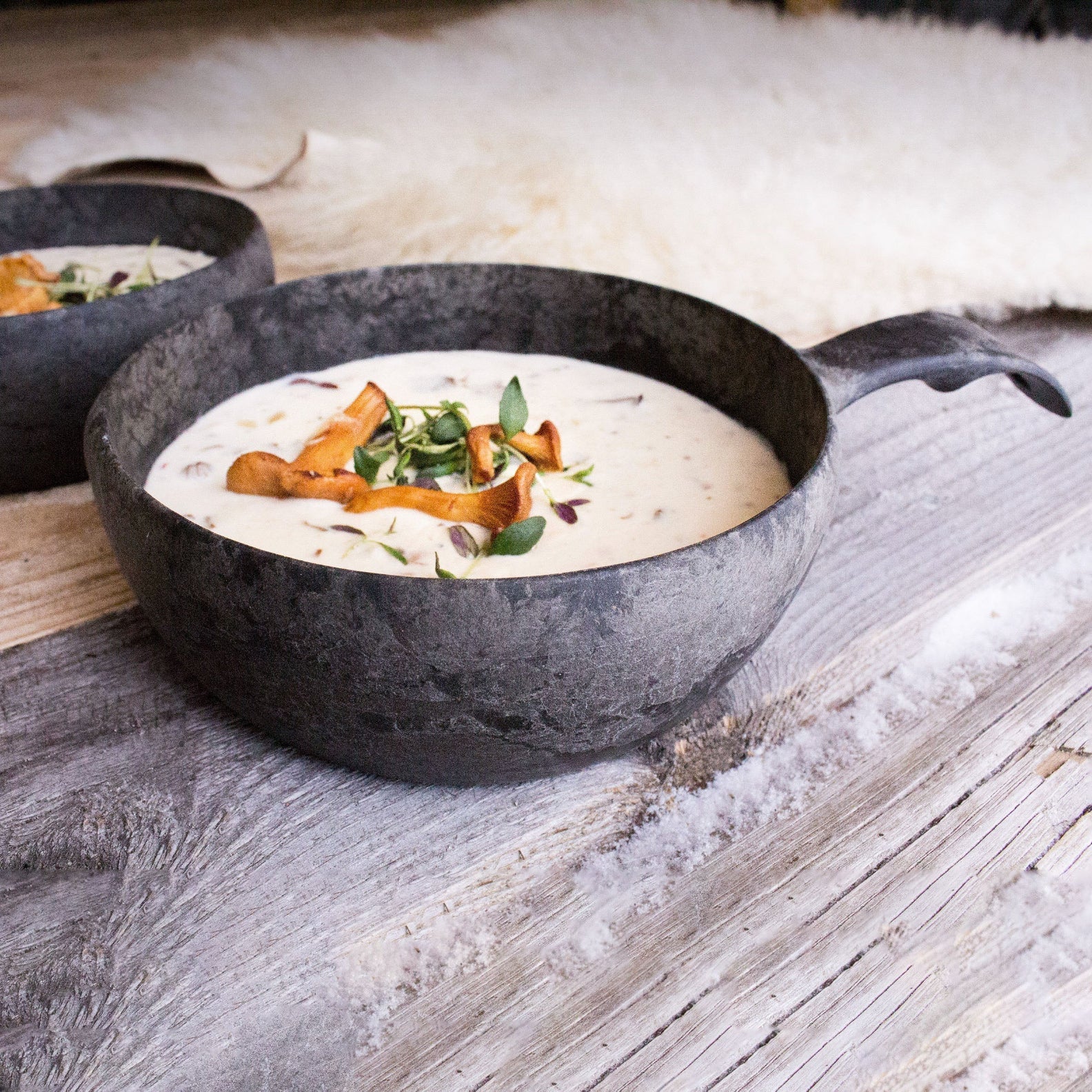 Creamy mushroom soup in a rustic Kupilka Bowl, perfect for country clothing lovers outdoors