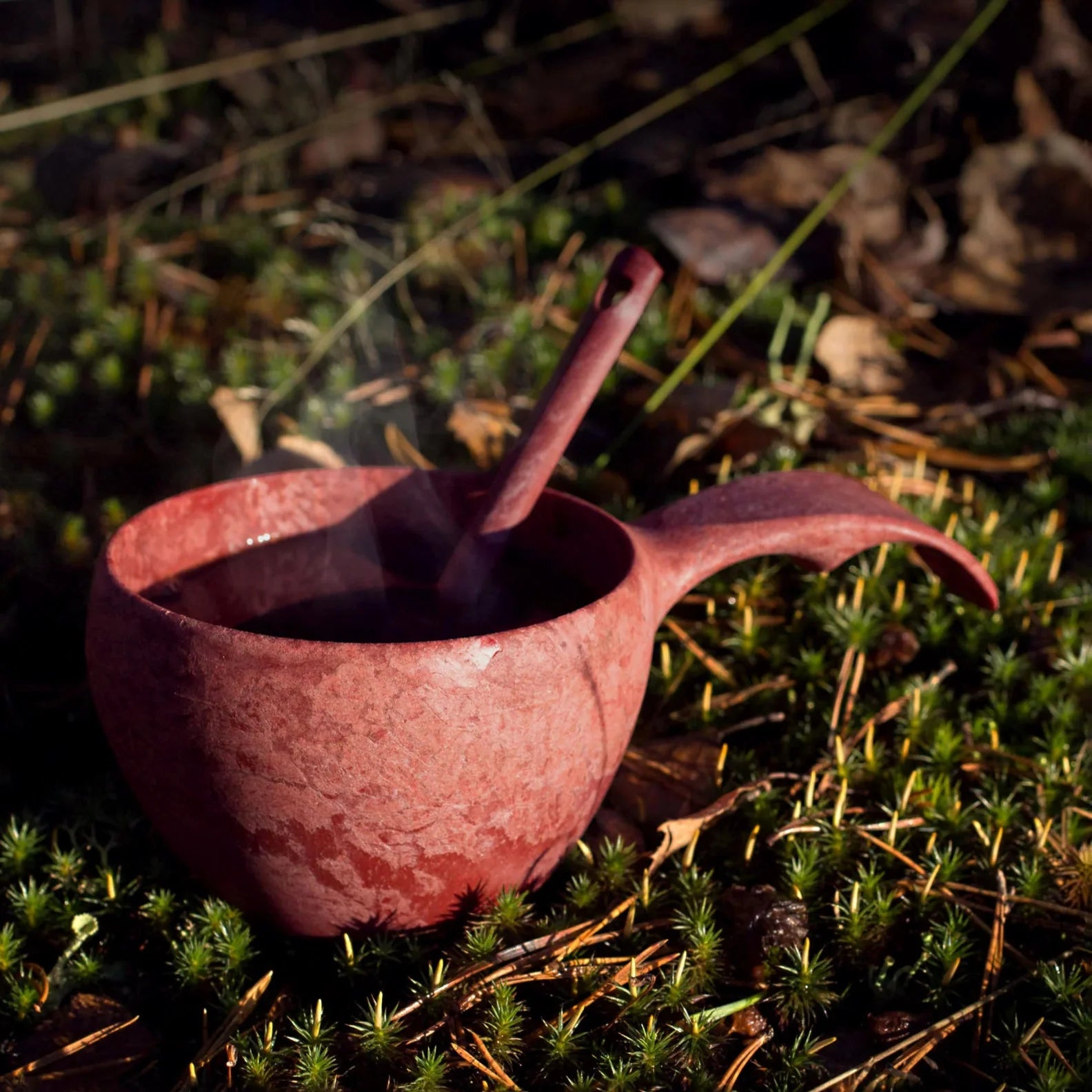 Reddish-brown Kupilka Classic Cup with handle and spoon, perfect for outdoors adventures