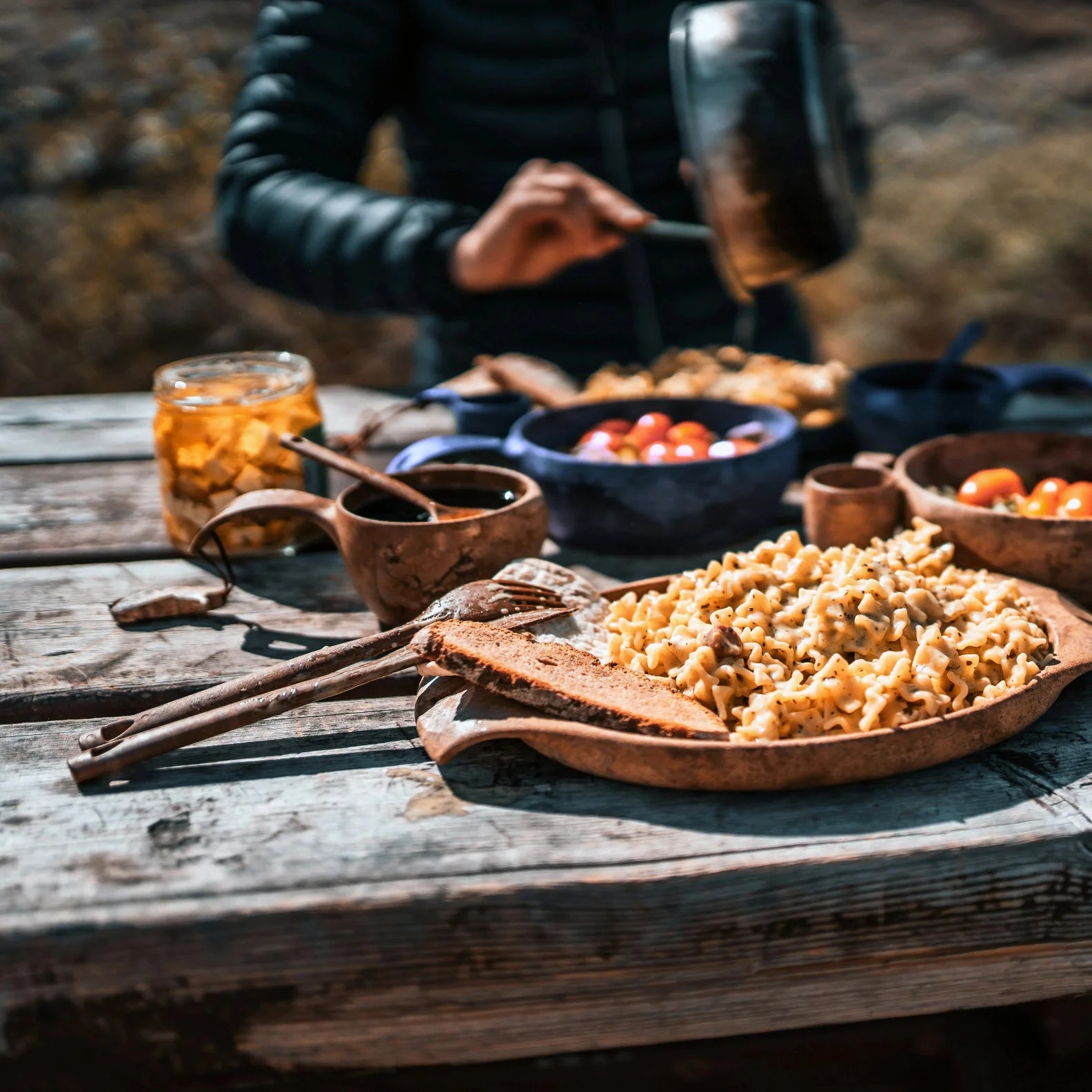 Rustic wooden bowls of food with Kupilka Cutlery Set for outdoor adventures and hunting