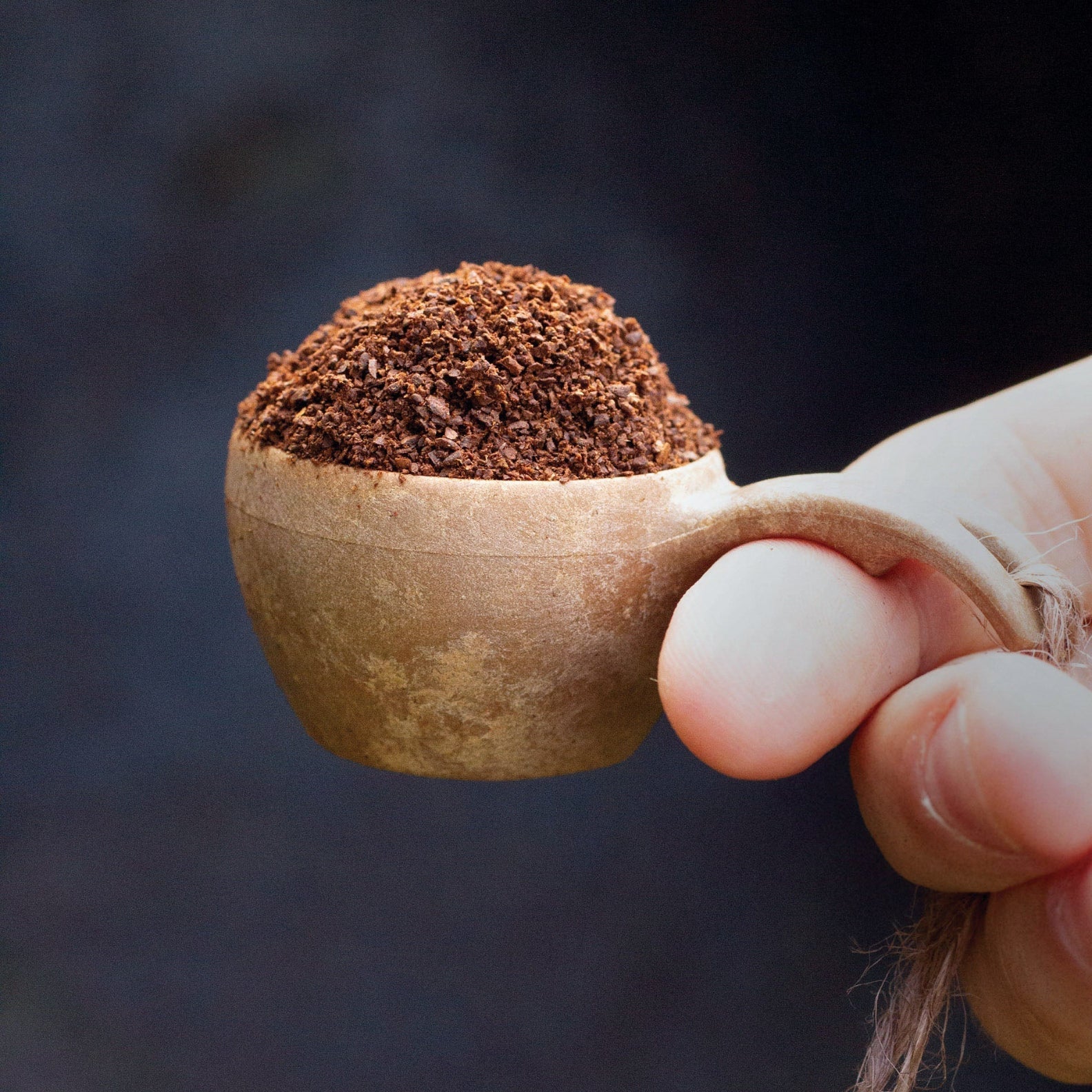 Scoop of ground coffee in a Kupilka Mini Cup for your perfect brew experience