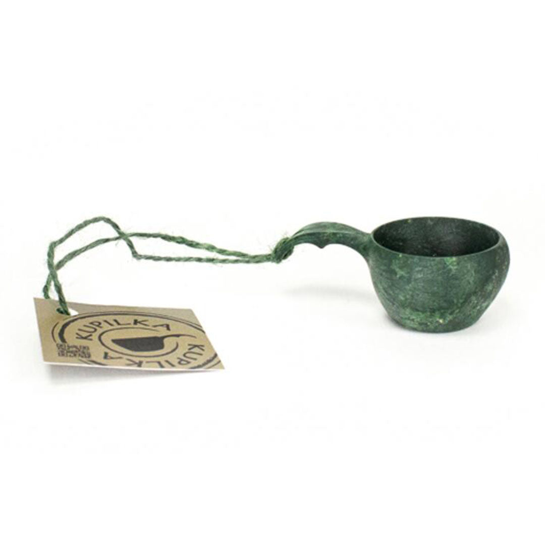 Green wooden Kupilka Mini Cup with a tag, perfect for eco-friendly sipping