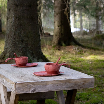 Rustic red ceramic teacups from the Kupilka Slow Down Gift Set, perfect for cozy tea time