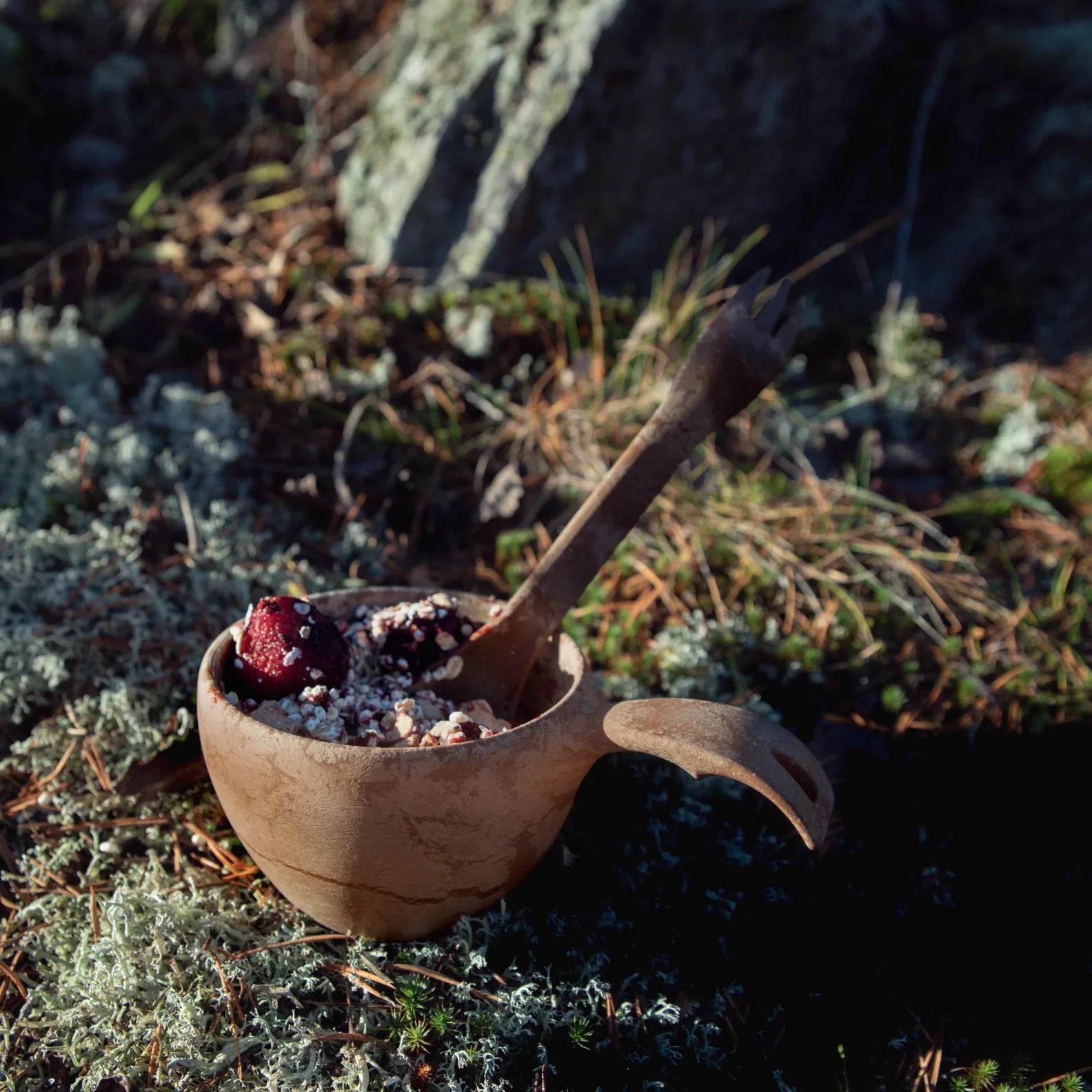 Wooden bowl with handle and spoon, perfect for country clothing adventures outdoors