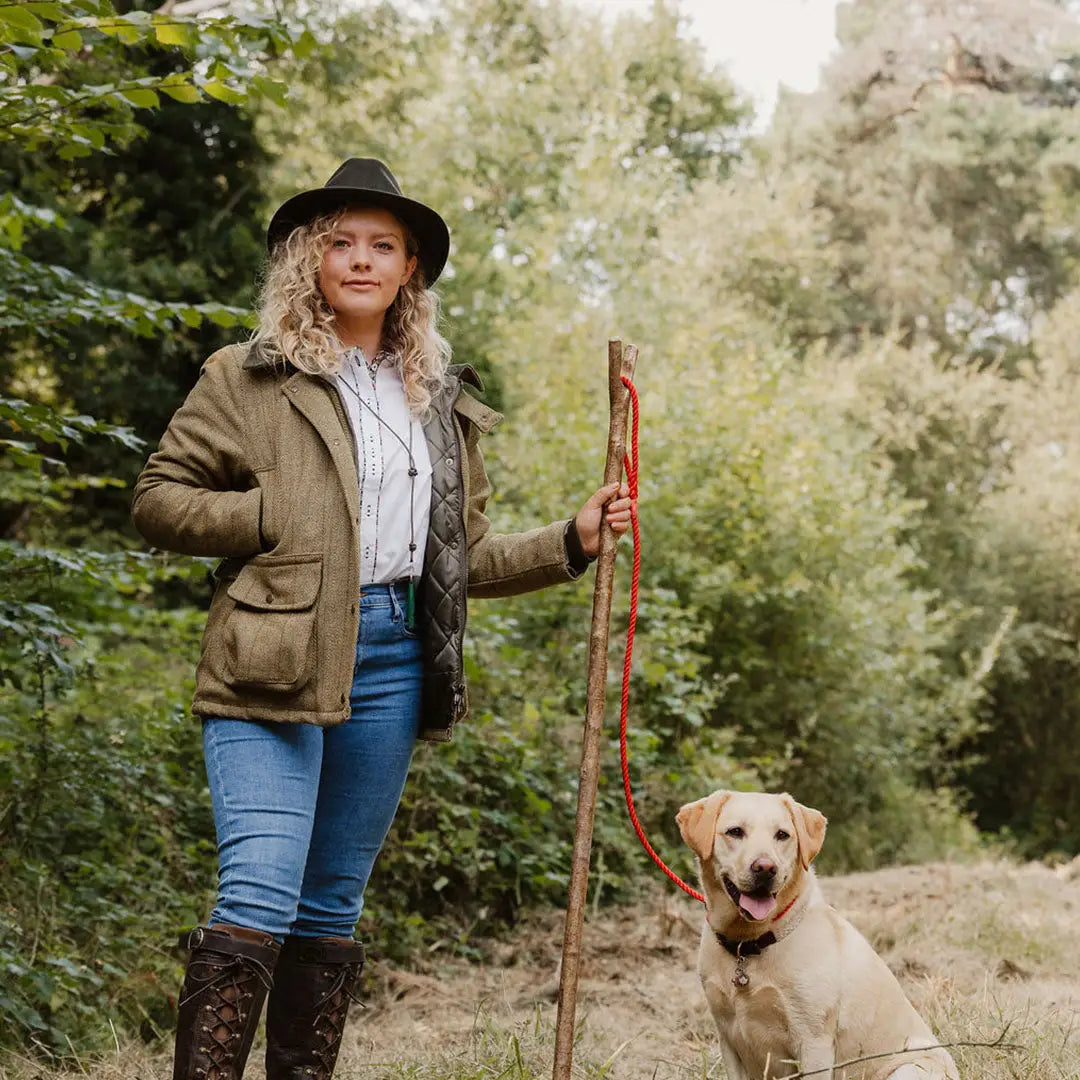 Woman in a Ladies Tweed Jacket walking her dog on a forest path, showcasing fantastic quality