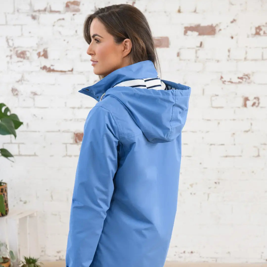 Blue hooded Lighthouse Beachcomber Ladies Waterproof Jacket on a stylish model