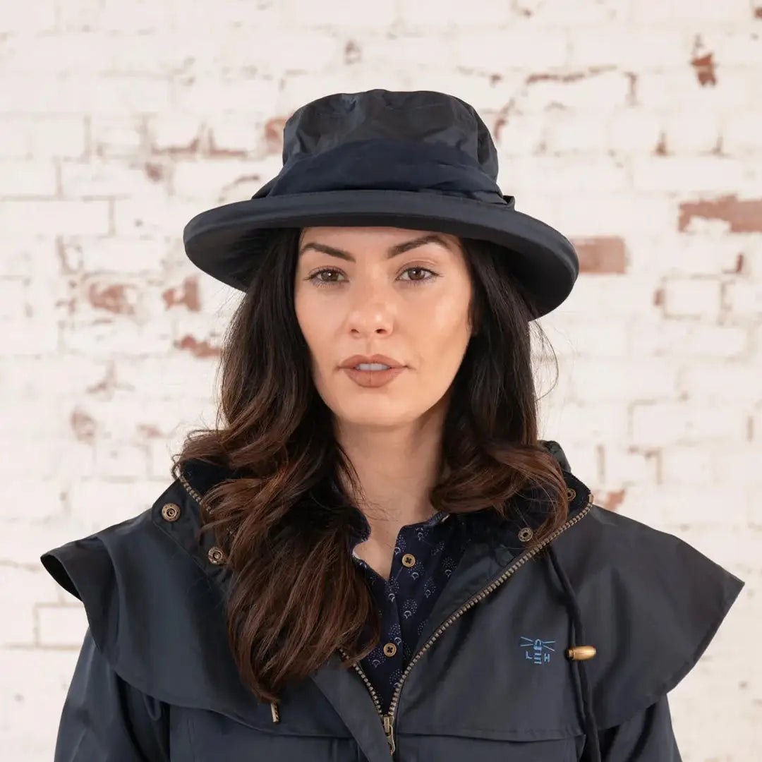 Woman in a dark blue wide-brimmed hat showcasing the Lighthouse Canterbury Waterproof Ladies Hat