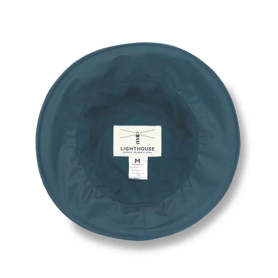 Teal circular plate with label for Lighthouse Canterbury Waterproof Ladies Hat