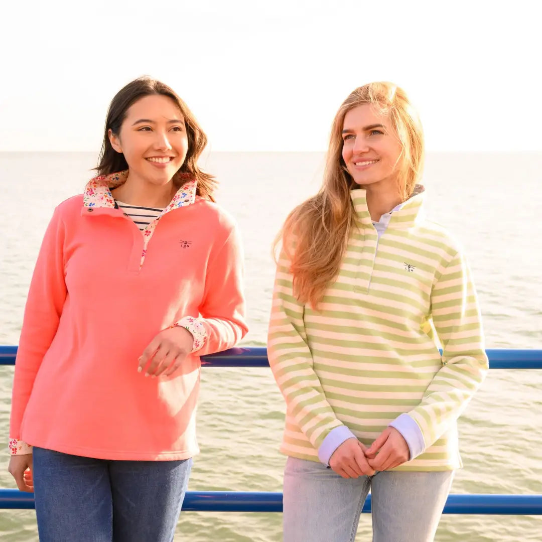 Two young women in colorful sweatshirts from Lighthouse Haven Ladies Jersey