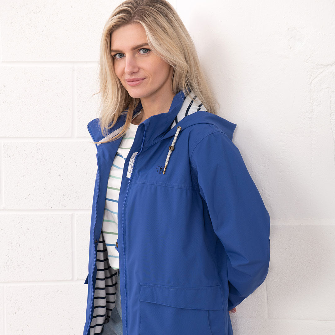 Blue hooded raincoat from the Lighthouse Ladies Beachcomber II Coat collection