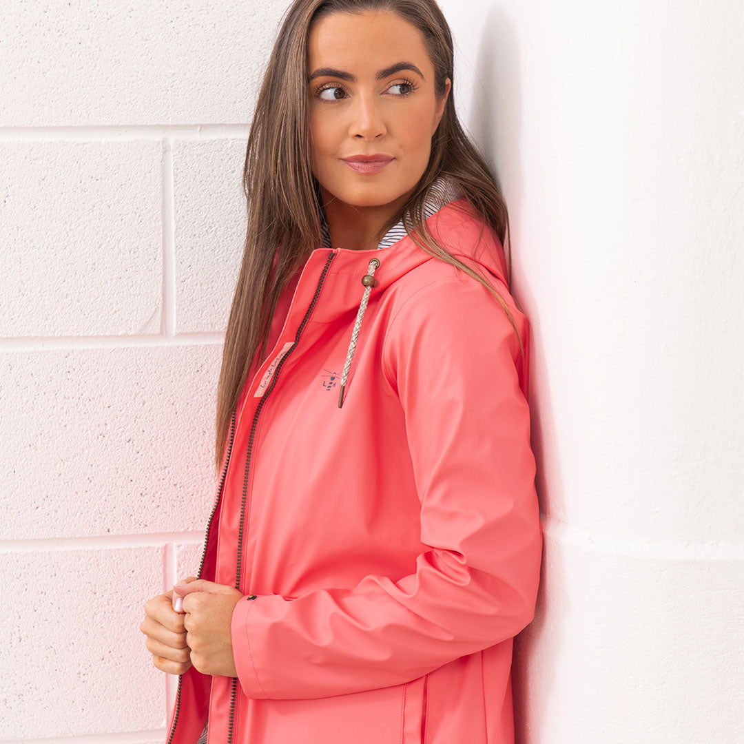 Coral-colored Lighthouse Ladies Lucy Coat, stylish and perfect for rainy days