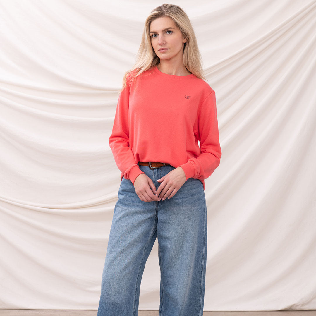 Woman rocking the Lighthouse Ladies Seaside Jersey in a coral sweatshirt and wide-leg jeans