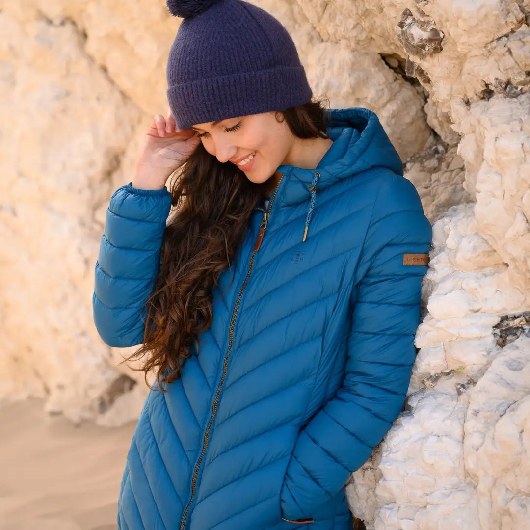 Person in a Blue Puffy Winter Jacket showcasing style combine with the Lighthouse Laurel Coat