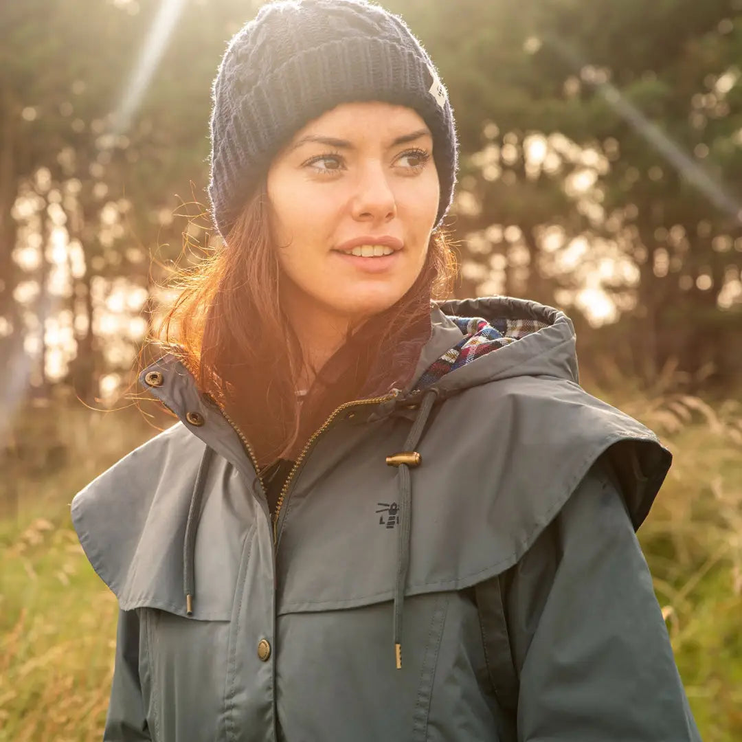 Woman in a gray Lighthouse Outback Full Length Ladies Waterproof Raincoat enjoying sunlight